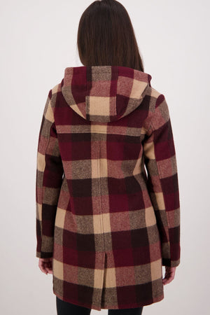 A person with long brown hair, seen from behind, wears the Swanndri Annmore V2 Wool Overcoat in burgundy, beige, and brown plaid—crafted from premium New Zealand wool—against a plain light background.