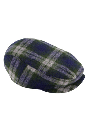 The Swanndri Bristol Flat Cap showcases a green, blue, and white Teddington Check pattern in soft wool-like fabric, displayed at an angle to highlight its top and part of the brim.