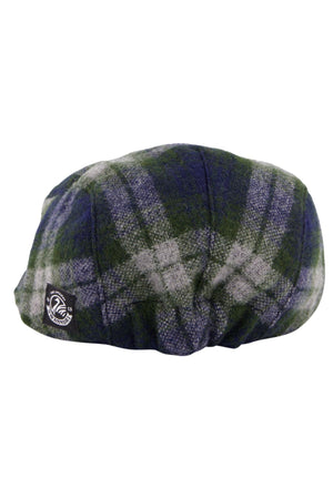 The Swanndri Bristol Flat Cap is crafted from premium merino wool in a green, blue, and gray Teddington Check plaid with a small black and white fabric logo patch on the side.