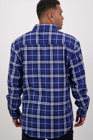 A person with short hair is standing and facing away from the camera, wearing a blue and white plaid long-sleeve shirt from the Swanndri Egmont Flannelette Twin Pack.