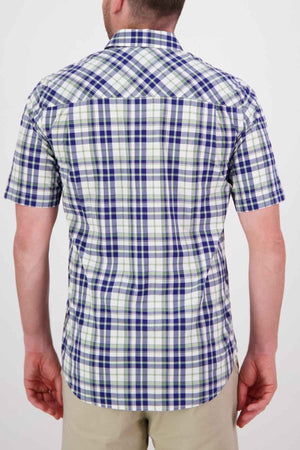 A person wearing the Swanndri Herbert Short Sleeve Shirt, a tailored fit in blue, green, and white plaid cotton, stands with their back to the camera. They are also dressed in beige pants against a plain white background.