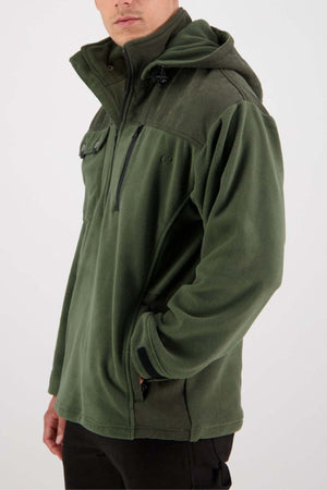 A person wearing a Swanndri High Rock Fleece Pullover in olive green with a high collar looks slightly towards the camera. The waterproof fabric jacket features multiple zippered pockets and is fastened with a black zipper running down the front. The background is plain white.