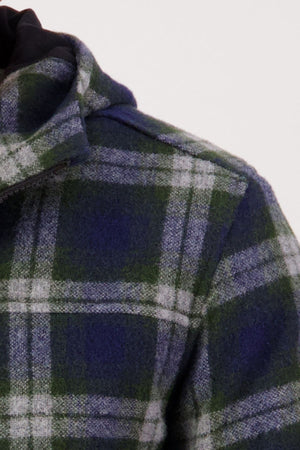 Close-up of a green, blue, and white plaid Swanndri Hudson Hoodie made from New Zealand wool with a collar, showing only the shoulder and upper chest against a plain light background.