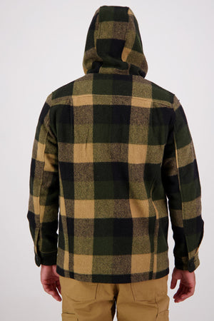 Wearing a Swanndri Hudson Hoodie with a large green, yellow, and black plaid New Zealand wool pattern and light brown pants, a person stands facing away against a plain white background.