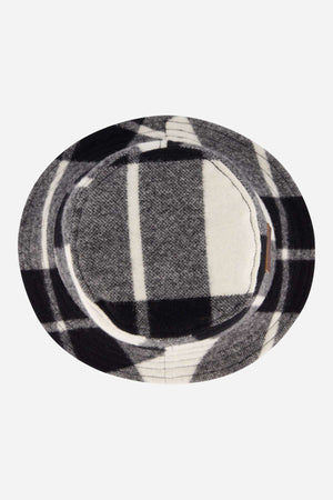 The Swanndri Kaimai Wool Bucket Hat features a round, flat brim and a black, white, and gray plaid pattern—shown from above on a plain white background—making it ideal for outdoor adventures.