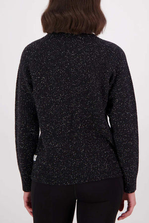A person with shoulder-length brown hair is shown from the back, wearing the Swanndri Lyttelton v2 Roll Neck Knit in black and black pants against a plain light background.