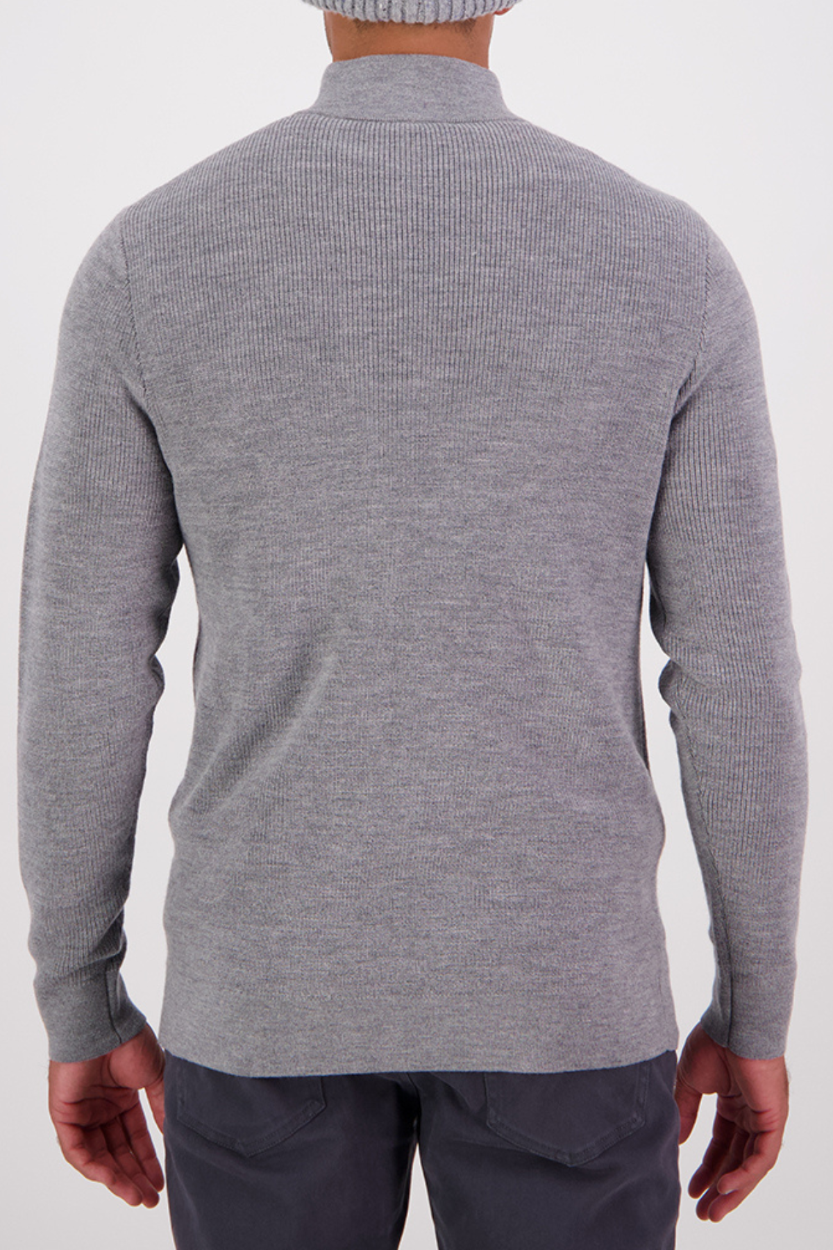 A person wearing a light gray Swanndri Otahu River Quarter Zip Merino Knit sweater and dark gray pants, shown from behind against a plain white background.