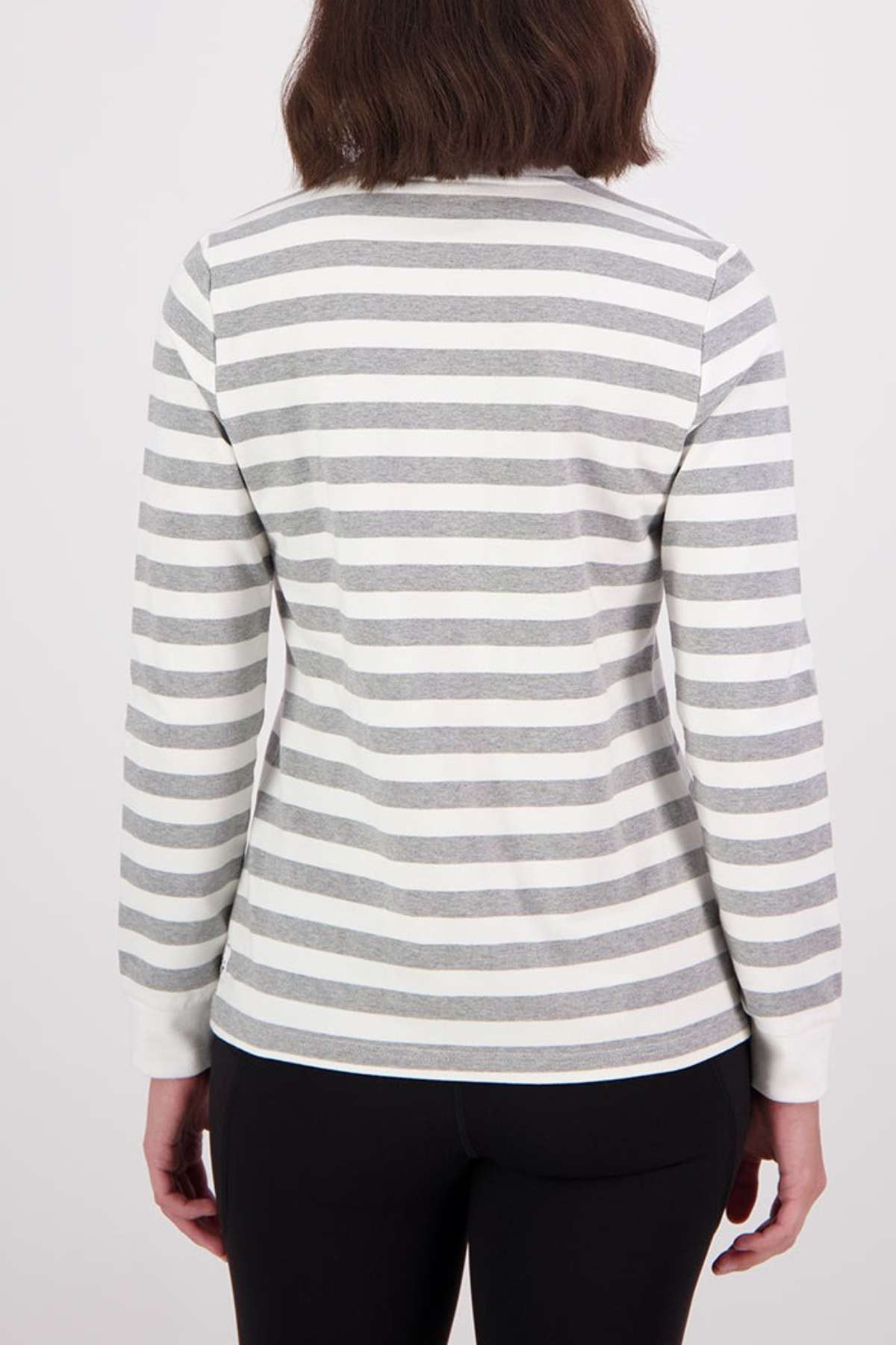 A person with shoulder-length brown hair, shown from the back, wears the Swanndri Papamoa Stripe Long Sleeve Tee with horizontal white and gray stripes and black pants against a plain light background.