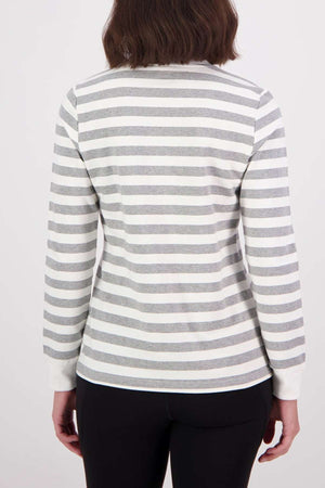 A person with shoulder-length brown hair, shown from the back, wears the Swanndri Papamoa Stripe Long Sleeve Tee with horizontal white and gray stripes and black pants against a plain light background.