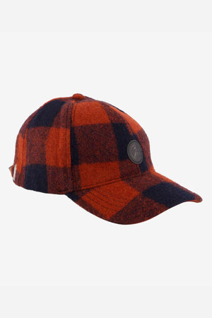 The Swanndri Swanni Wool Check Baseball Cap features a red and black plaid pattern, a round black emblem on the front, a curved brim, and an adjustable fit for stylish comfort on any casual outing.