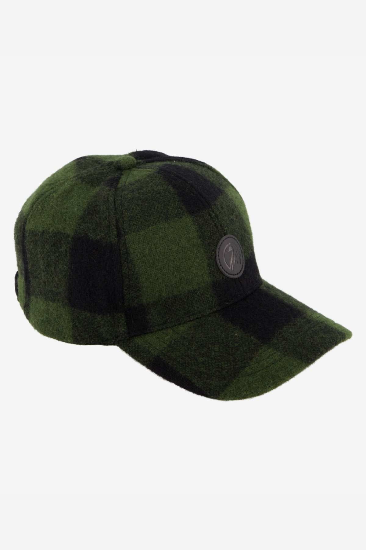 The Swanndri Swanni Wool Check Baseball Cap, in green and black plaid with a round black side patch, is shown on a white background.