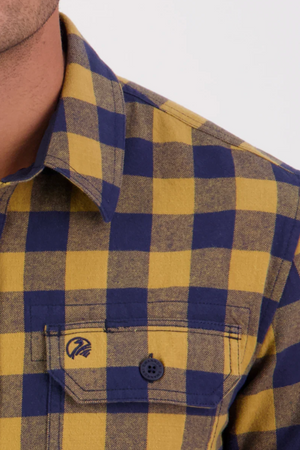 Close-up of a shoulder wearing the Swanndri Taranaki Tailor Shirt, 100% cotton with yellow and blue checks, buttoned chest pockets, and a visible collar.