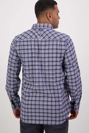 A person faces away from the camera, wearing a blue and white checkered Swanndri Wendon Shirt made of 100% cotton. The classic fit shirt enhances their short dark hair and dark pants against a plain backdrop.