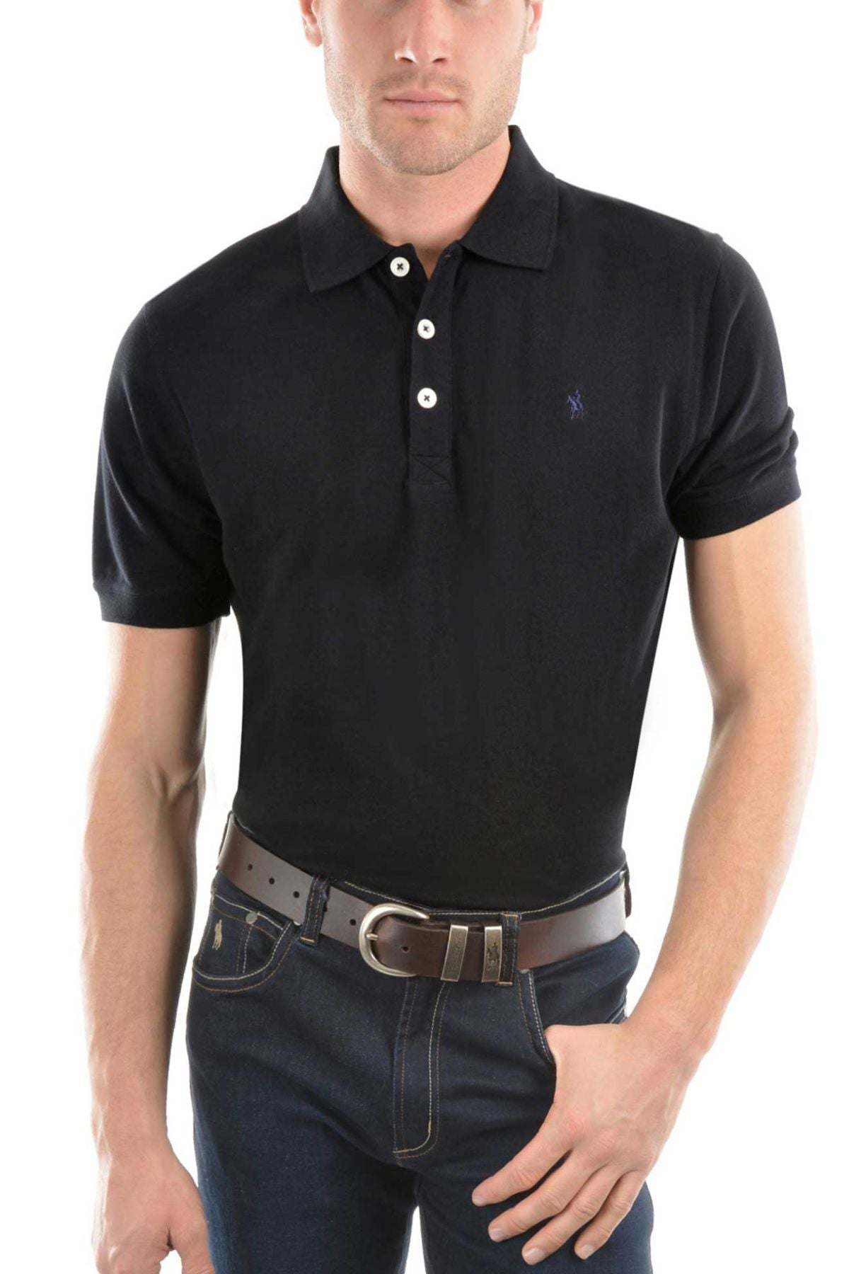 A man wears the Thomas Cook Tailored Polo in black with white buttons, paired with dark blue jeans and a brown belt, standing with one hand in his pocket against a white background.