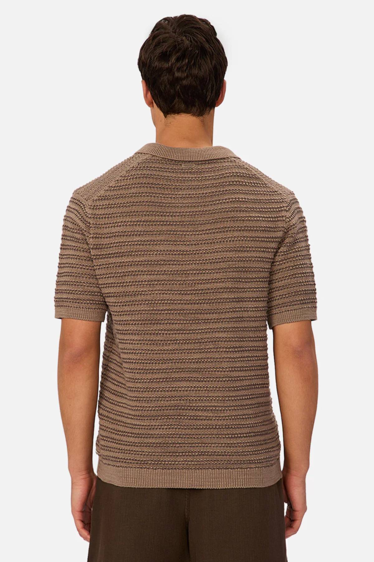 A man is seen from behind wearing the Industrie The Matera Polo in a textured brown knit paired with dark brown pants, set against a plain white background.