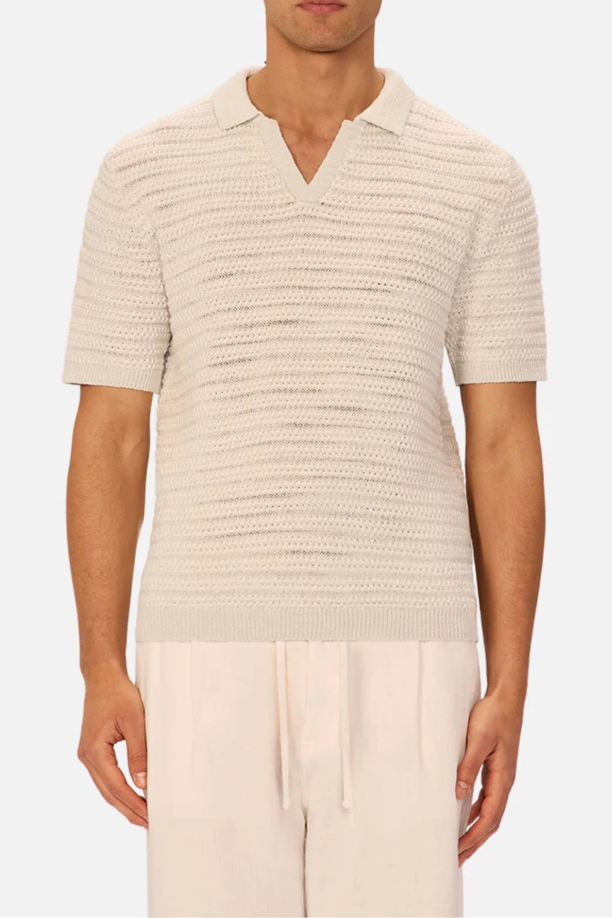 A man wearing the Industrie The Matera Polo, a heavyweight knitted polo in white.