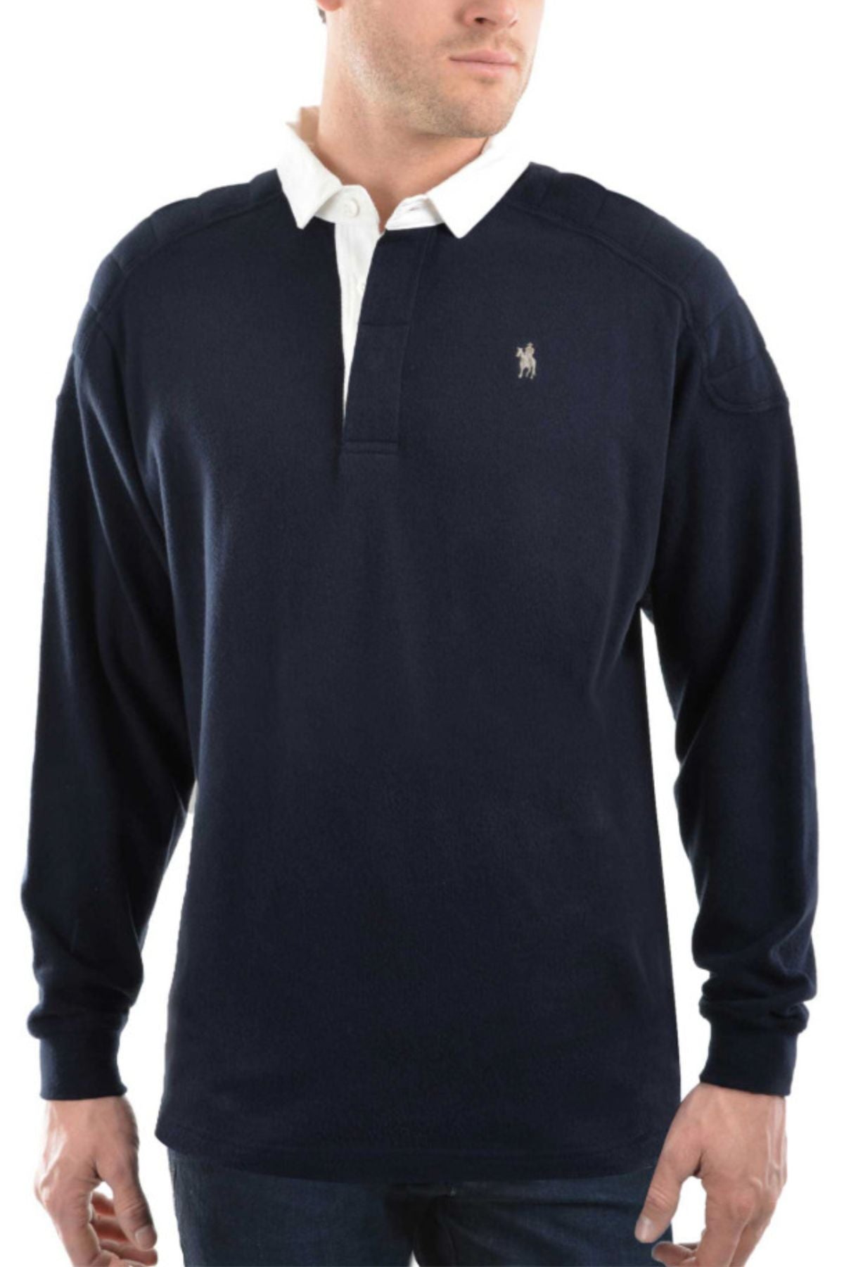 A man wears the Thomas Cook Bill Rugby, a long-sleeve navy blue cotton jersey shirt with white collar, buttons, and small embroidered chest logo, paired with blue jeans.