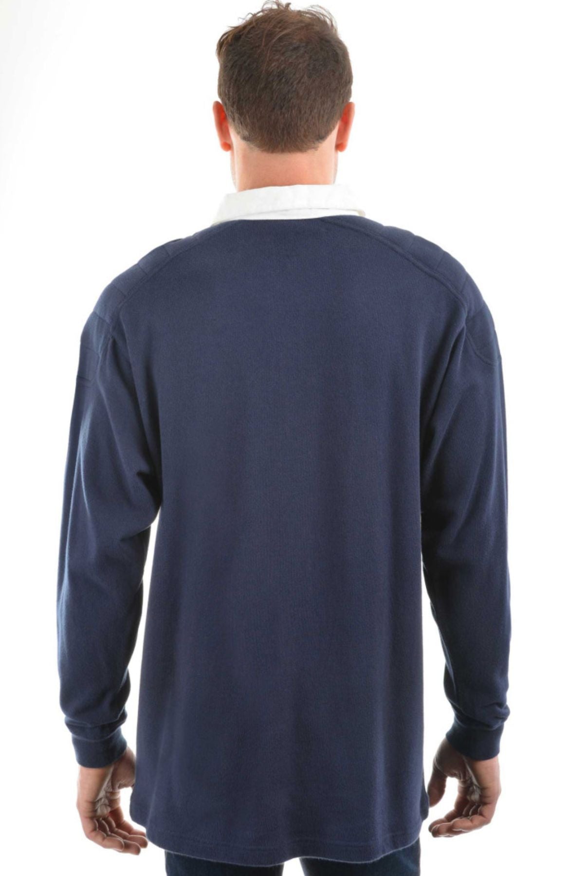 A man faces away from the camera, wearing the Thomas Cook Bill Rugby—a long-sleeve navy cotton jersey shirt with a white collar—against a plain white background.