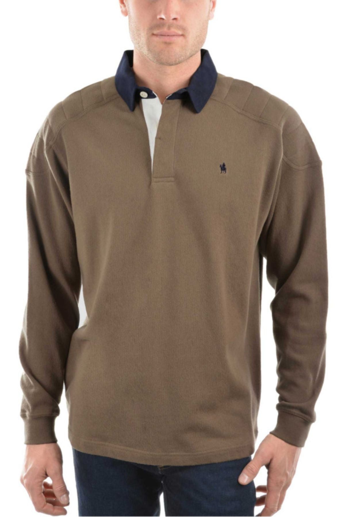 A man wears the Thomas Cook Bill Rugby shirt—brown, long-sleeve, cotton with a navy collar and small left chest logo—paired with dark blue jeans.