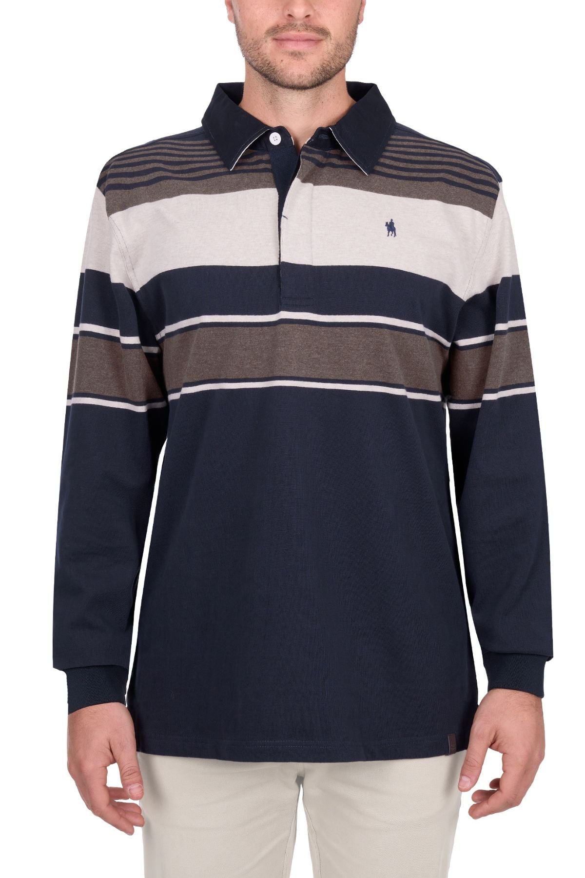 A man wears the Thomas Cook Bryan Stripe Rugby, a long-sleeve collared shirt with navy, beige, and brown stripes and a small embroidered logo on the chest, paired with light-colored pants.