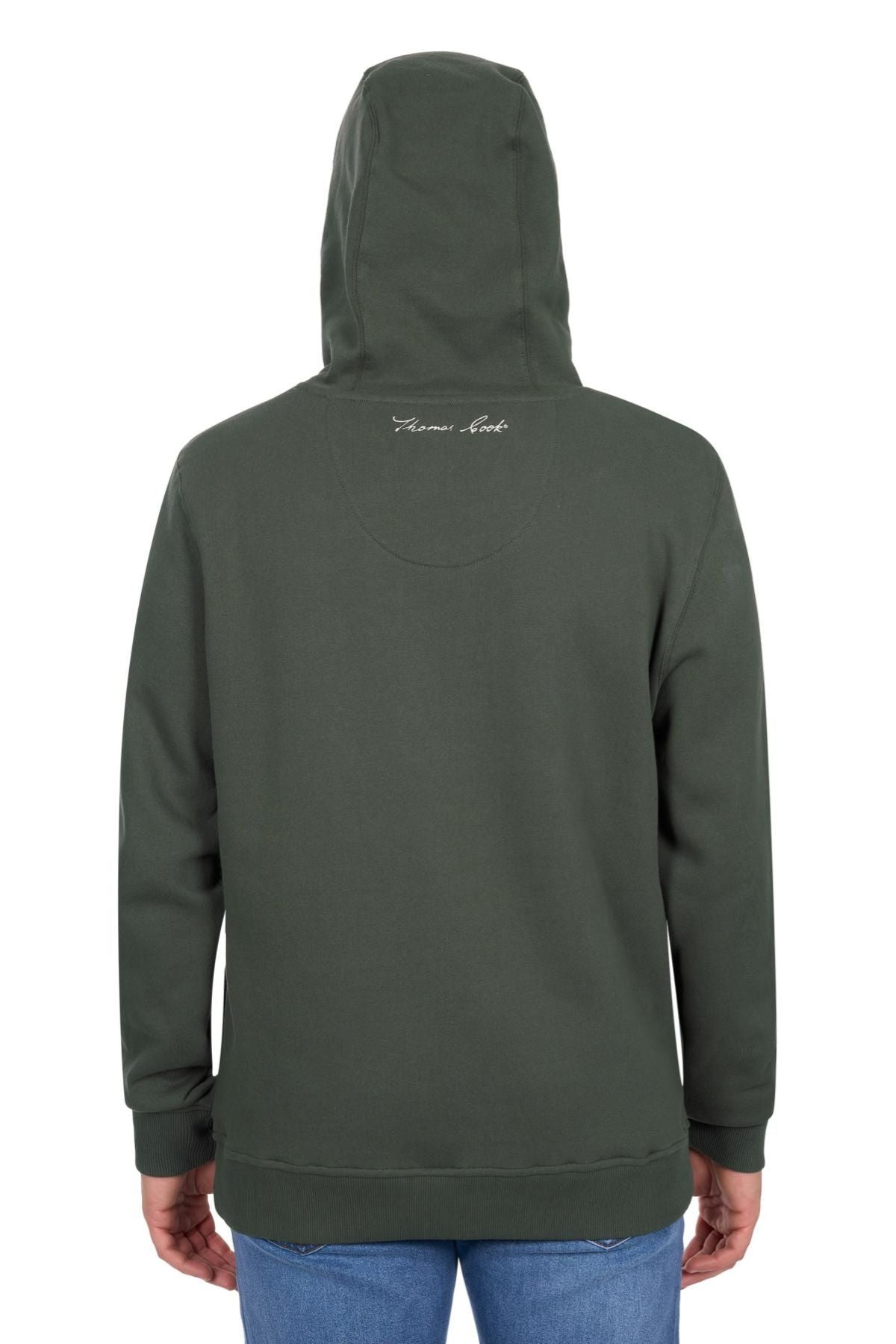 A person is seen from behind wearing the Thomas Cook Heritage C N C Hoodie in dark green brushed fleece, hood up, featuring a small white script logo on the upper back, paired with blue jeans.
