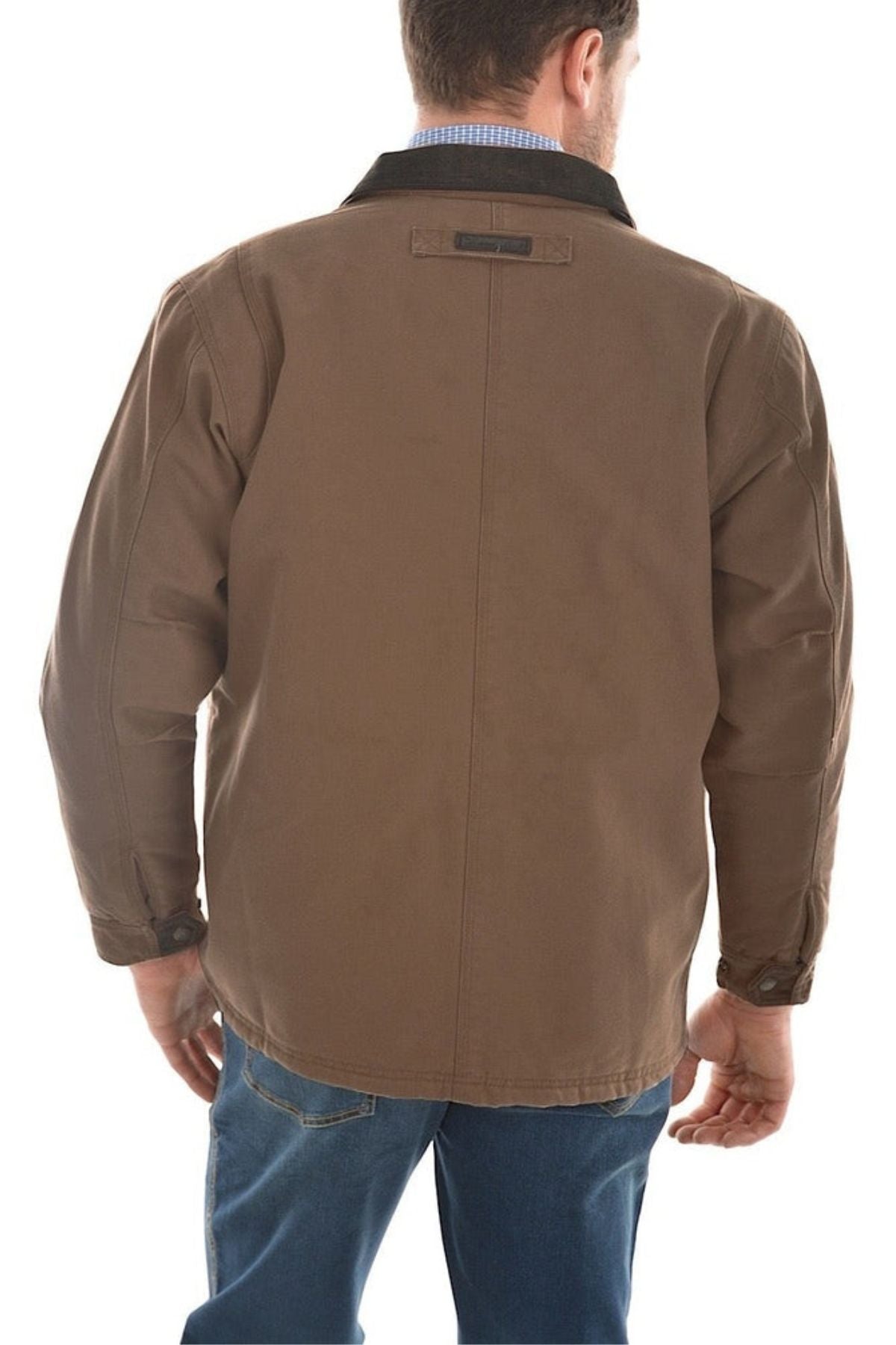 A man facing away from the camera wears a Thomas Cook Canvas Jacket with a black collar, blue jeans, and a blue checkered shirt visible at the neck.