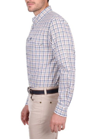 A man stands sideways against a white background wearing the Thomas Cook Chad Shirt—blue and brown checkered, long sleeves—tucked into beige pants with a dark belt.