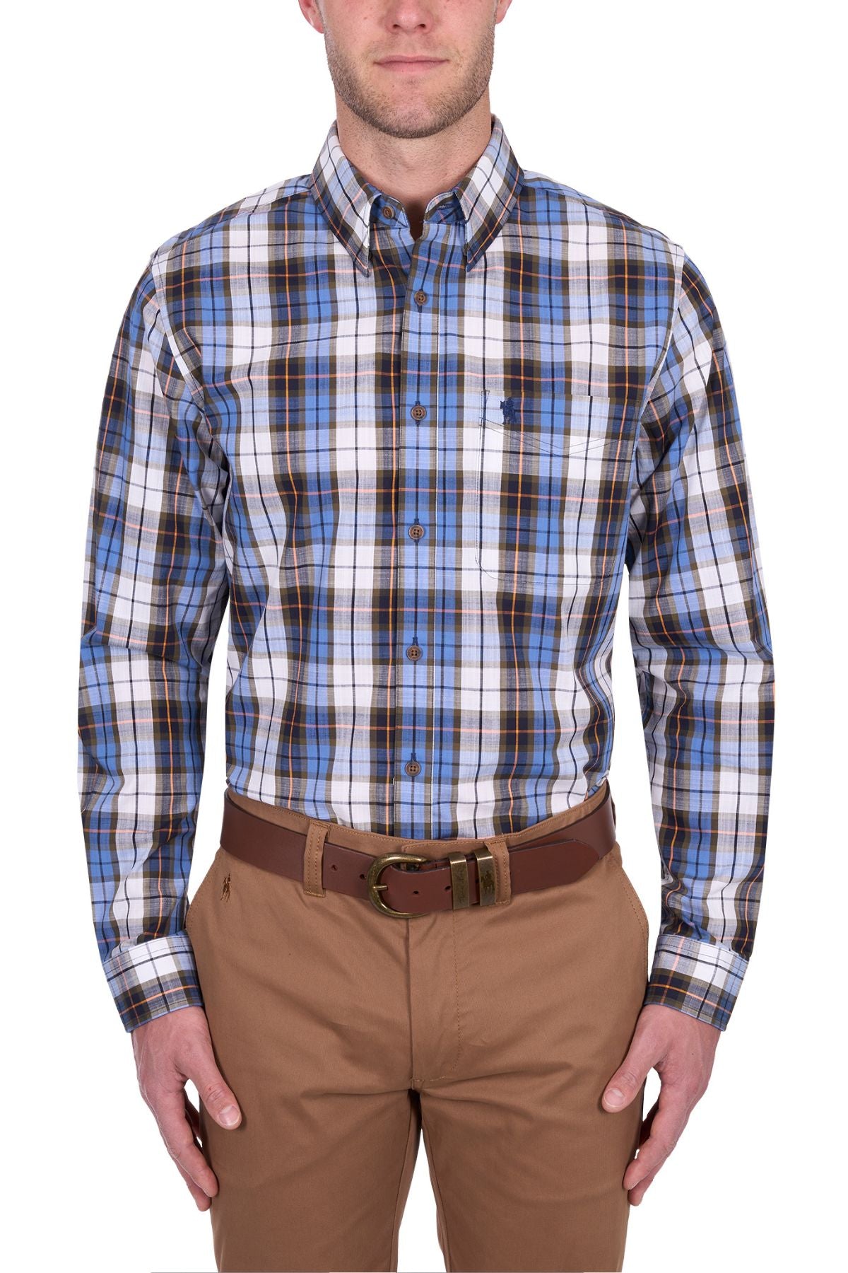 A man wears the Thomas Cook Daniel Shirt, a blue, brown, and white yarn-dyed check long-sleeve shirt tucked into tan pants with a brown belt, standing against a white background.