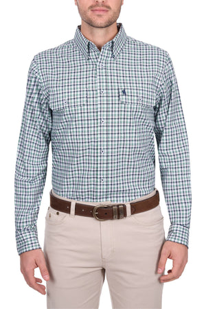 A man stands facing forward against a white background, wearing a green and blue Thomas Cook Edward Shirt paired with beige pants and a brown belt.