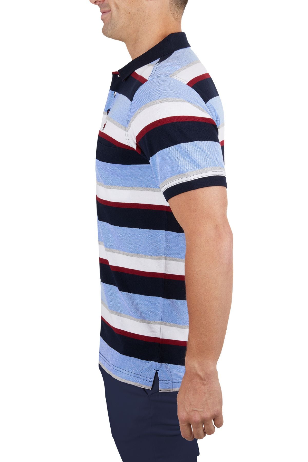 A man in profile wears the Thomas Cook Gavin Polo—100% cotton with blue, white, red, and navy stripes—and dark pants against a plain white background.