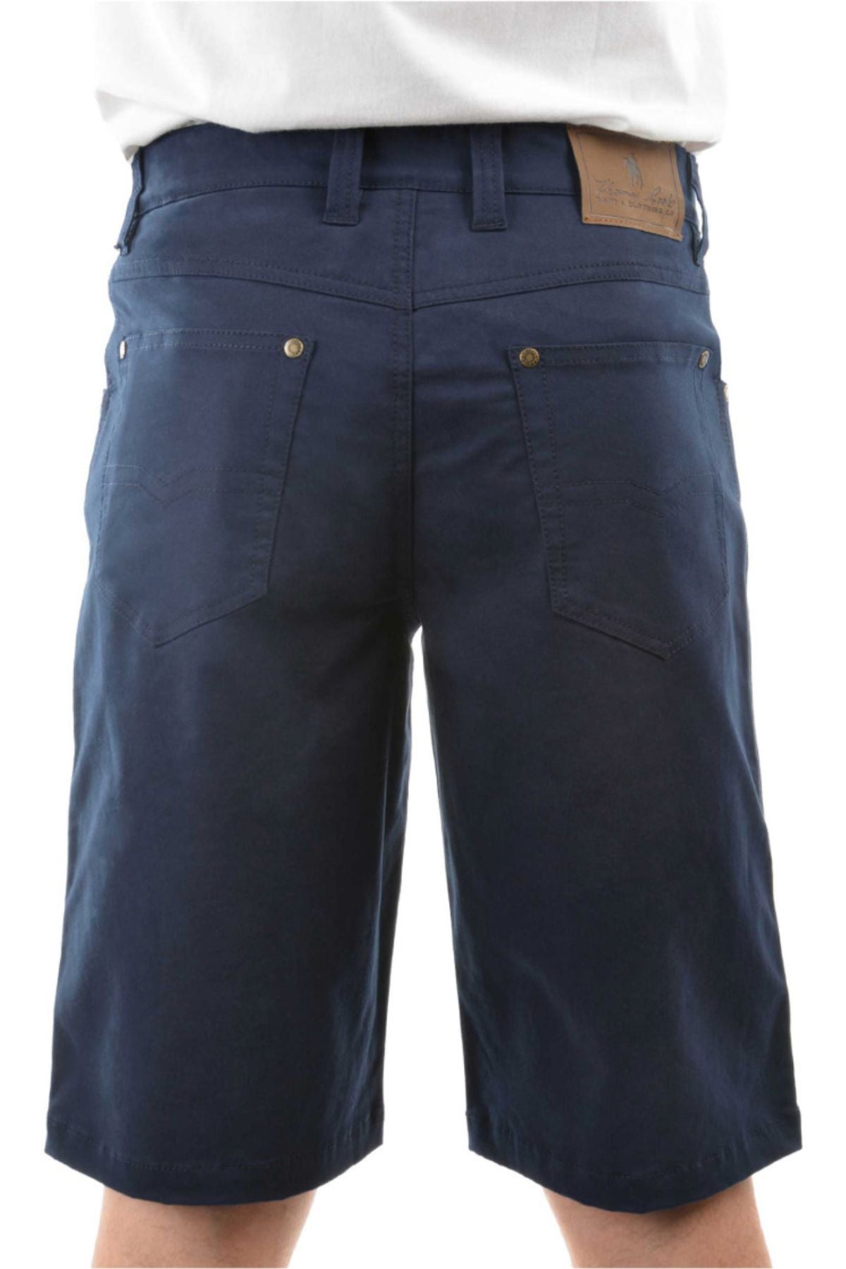 Someone is seen from the back wearing dark blue Thomas Cook Jake Comfort Waist Shorts, featuring stretch fabric, back pockets, belt loops, and a brown leather patch on the waistband.