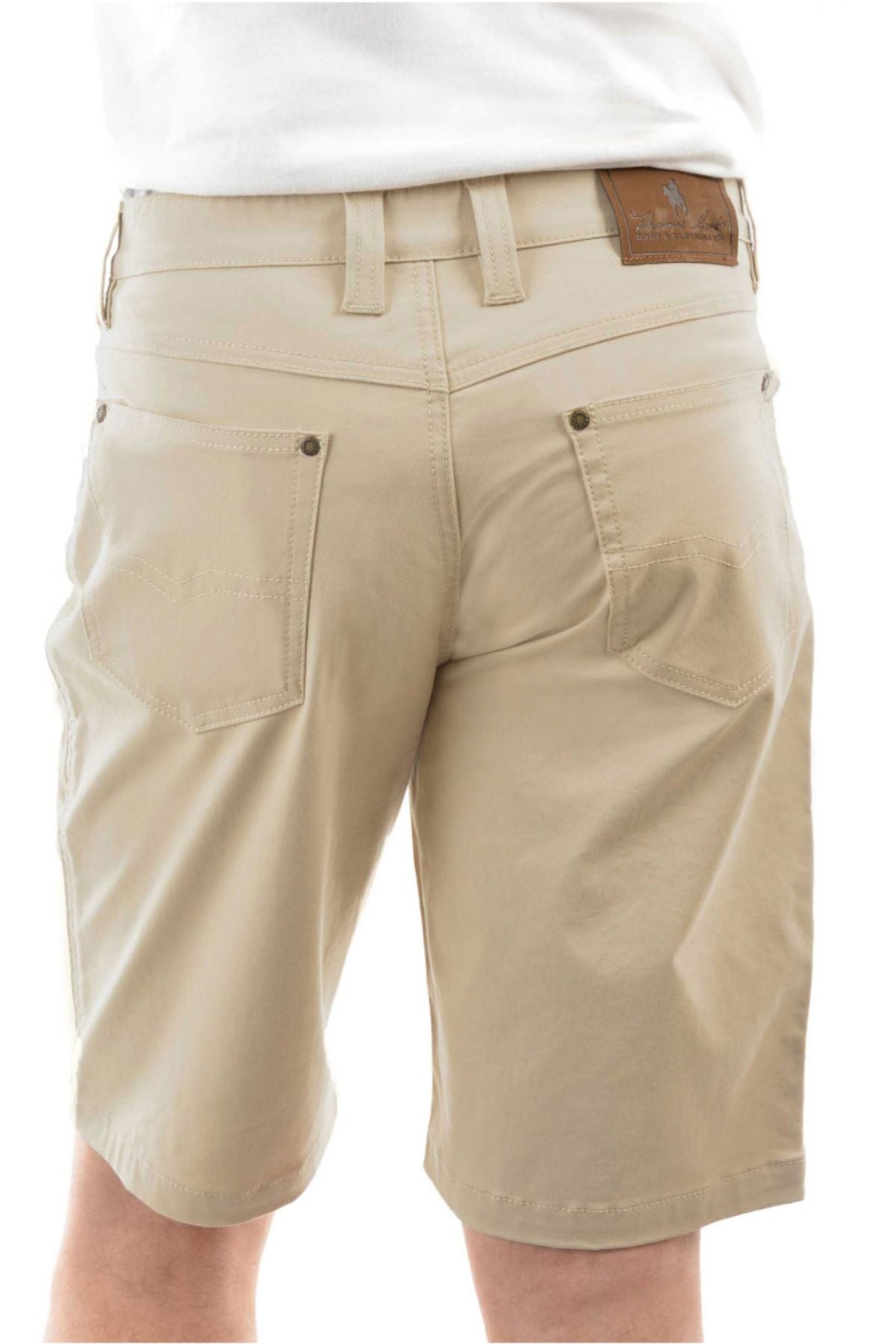A person wearing Thomas Cook Jake Comfort Waist Short in light khaki and a white shirt is shown from the waist down, back view. The shorts feature large back pockets, belt loops, stretch fabric, and a brown leather patch on the waistband.