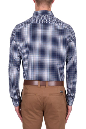 A man stands with his back to the camera, wearing the Thomas Cook Jason Tailored Shirt in navy and white checks, tucked into tan pants with a brown belt, set against a white background.