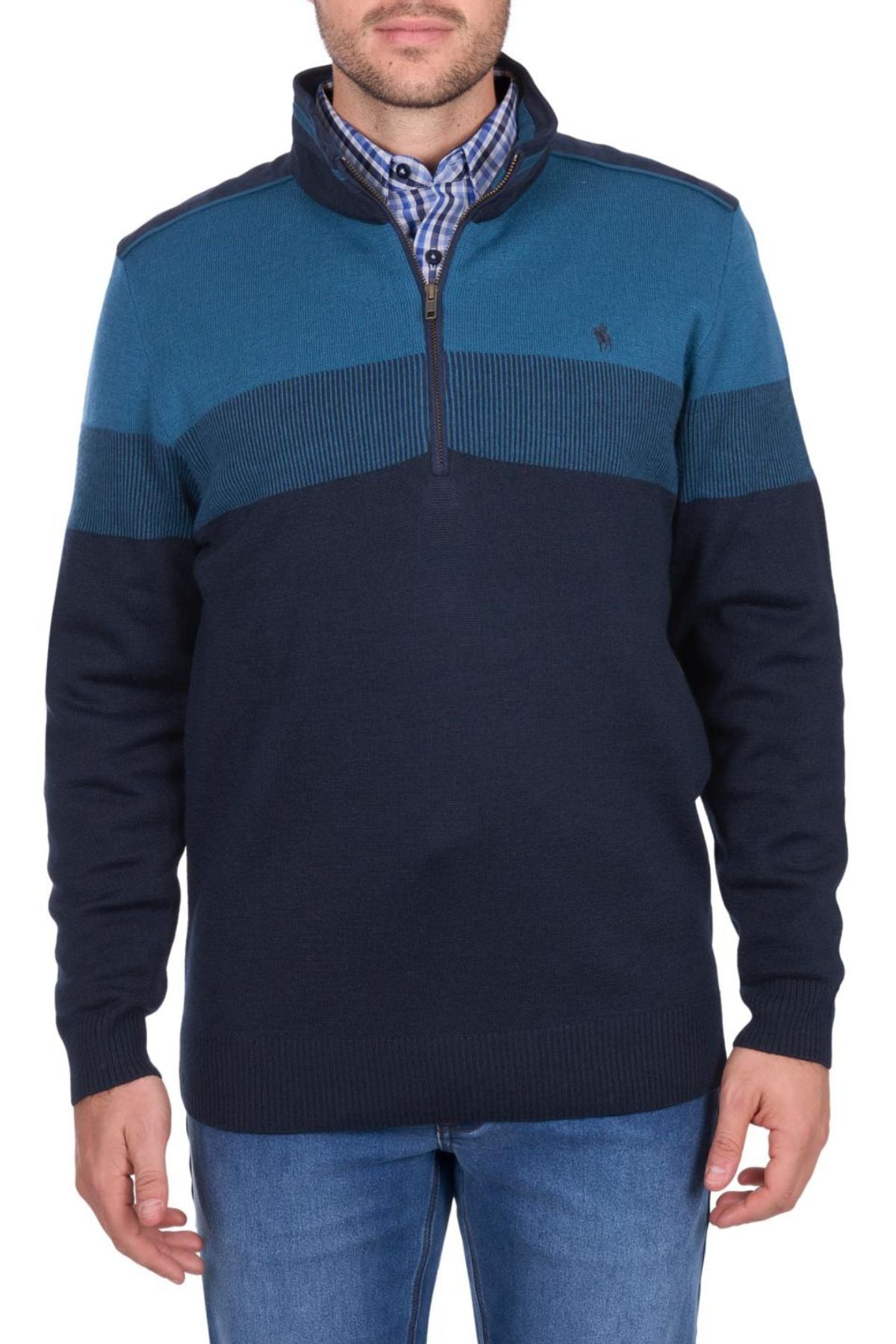 A man wearing a Thomas Cook Jerry 1/4 Zip Jumper with a half-zip collar and horizontal teal stripe, over a blue plaid shirt and blue jeans, stands against a plain white background.