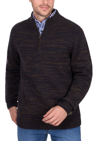 A man stands against a white background wearing the Thomas Cook Jesse 1/4 Zip Jumper over a blue plaid shirt and blue jeans, with his face partially visible.