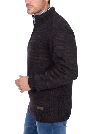 A man wearing a Thomas Cook Jesse 1/4 Zip Jumper and blue jeans stands sideways against a white background.