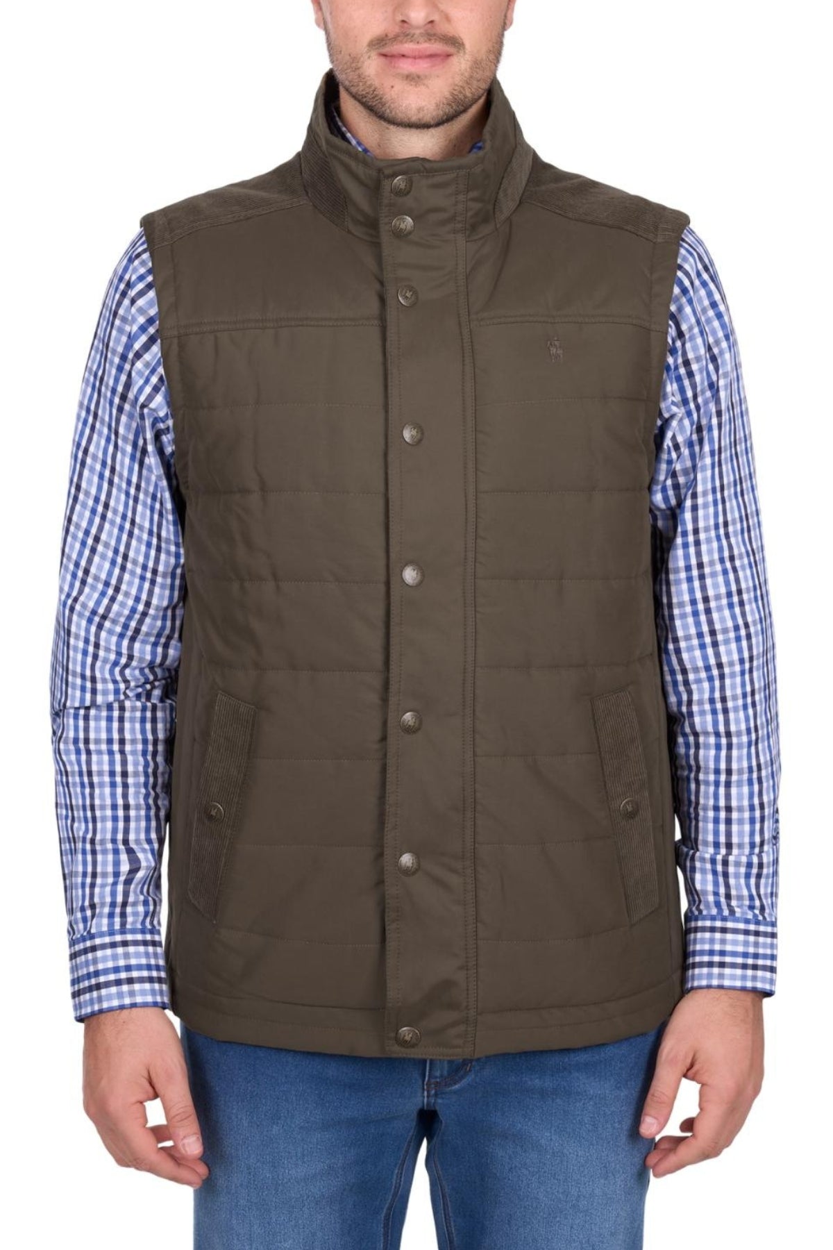 A man wearing the Thomas Cook Matt Vest, a khaki quilted and lined vest for warmth, over a blue and white checkered shirt with blue jeans stands against a white background.