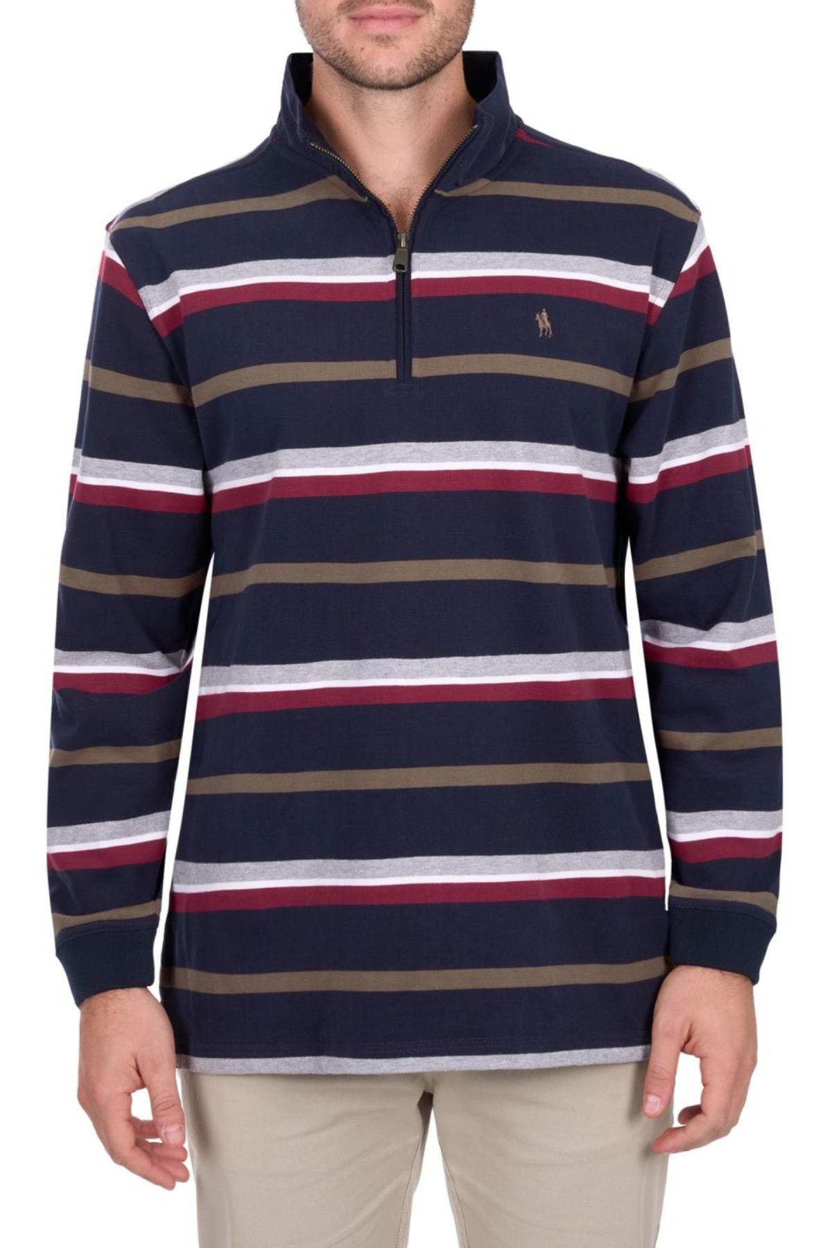 A man wears the Thomas Cook Nicholas 1/4 Zip Rugby—a heavyweight, long-sleeve jersey with navy, burgundy, white, and olive green stripes and a small embroidered logo on the left chest—paired with beige pants.