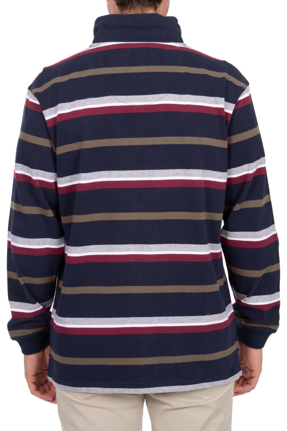 A person is seen from the back wearing the Thomas Cook Nicholas 1/4 Zip Rugby, a heavyweight 100% cotton jersey with navy, white, red, and olive green stripes, paired with light-colored pants.