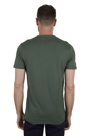 A man faces away from the camera, wearing a Thomas Cook Oval Tee—classic fit, 100% cotton, dark green—with dark pants, set against a plain white background.