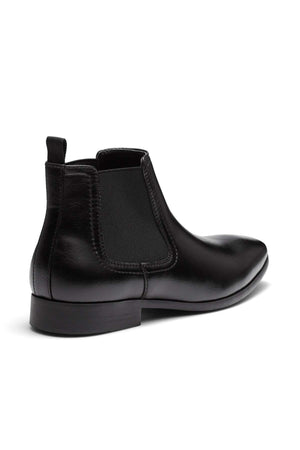 Introducing the UNcut Newlands Boot: a versatile black leather ankle boot designed with an almond toe shape. This stylish footwear features an elastic side panel and a convenient pull-tab at the heel. With its low heel and smooth finish, it's perfect for pairing with both formal and casual attire. Available in UK sizing to ensure a perfect fit.