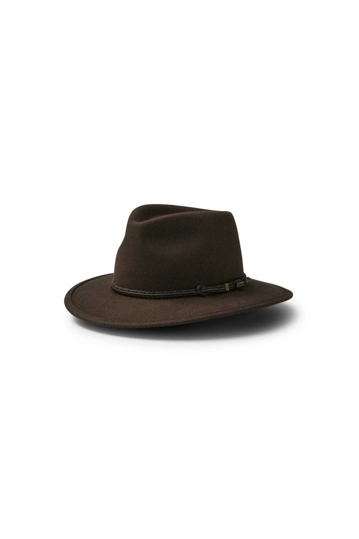 The Akubra Traveller is a dark brown hat featuring a wide brim, a slightly creased crown, and a thin braided band at the base, shown against a white background.