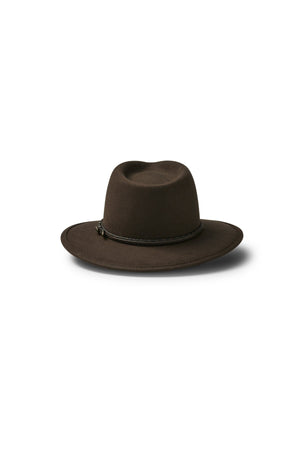 The Akubra Traveller is a dark brown, wide-brimmed felt fedora with a simple braided band around the crown, shown on a white background with a soft shadow.