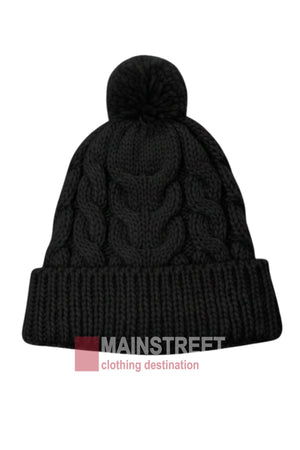 The Anticorp Ladies Cable Lined Beanie features a black cable knit design, folded cuff, playful pom-pom, and the "MAINSTREET clothing destination" logo—an essential accessory for cozy style.