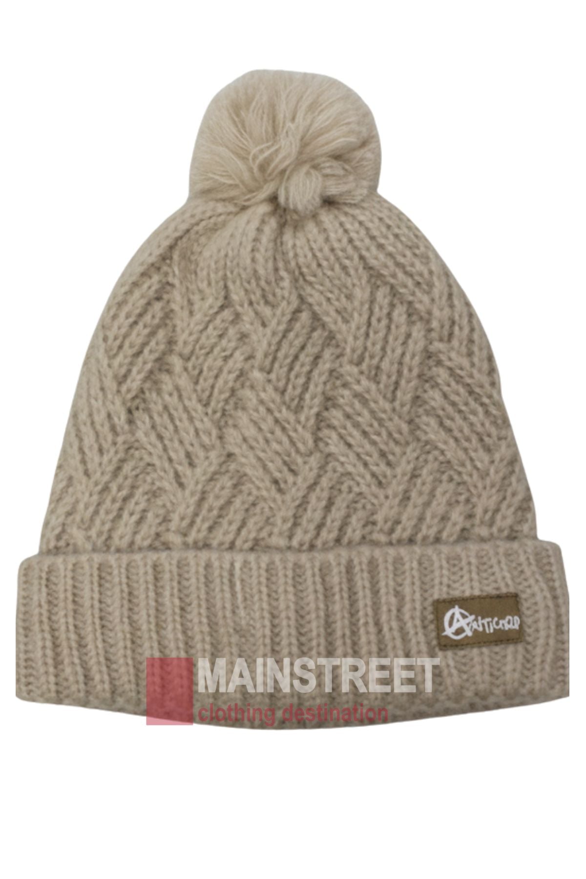 The Anticorp Ladies Herringbone Beanie is beige with a folded brim, a zigzag herringbone pattern, a pom-pom on top, and features a small brown tag with white lettering on the brim.