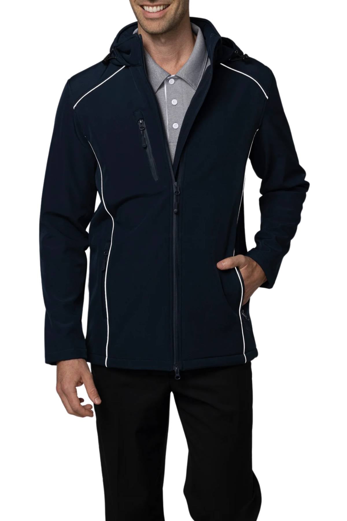 A man wears the Aussie Pacific Aspen Softshell Jacket with white piping, layered over a gray collared shirt and paired with black pants. The jacket includes an adjustable hem, hood, and zippered chest pocket. He is smiling with one hand in his pocket.