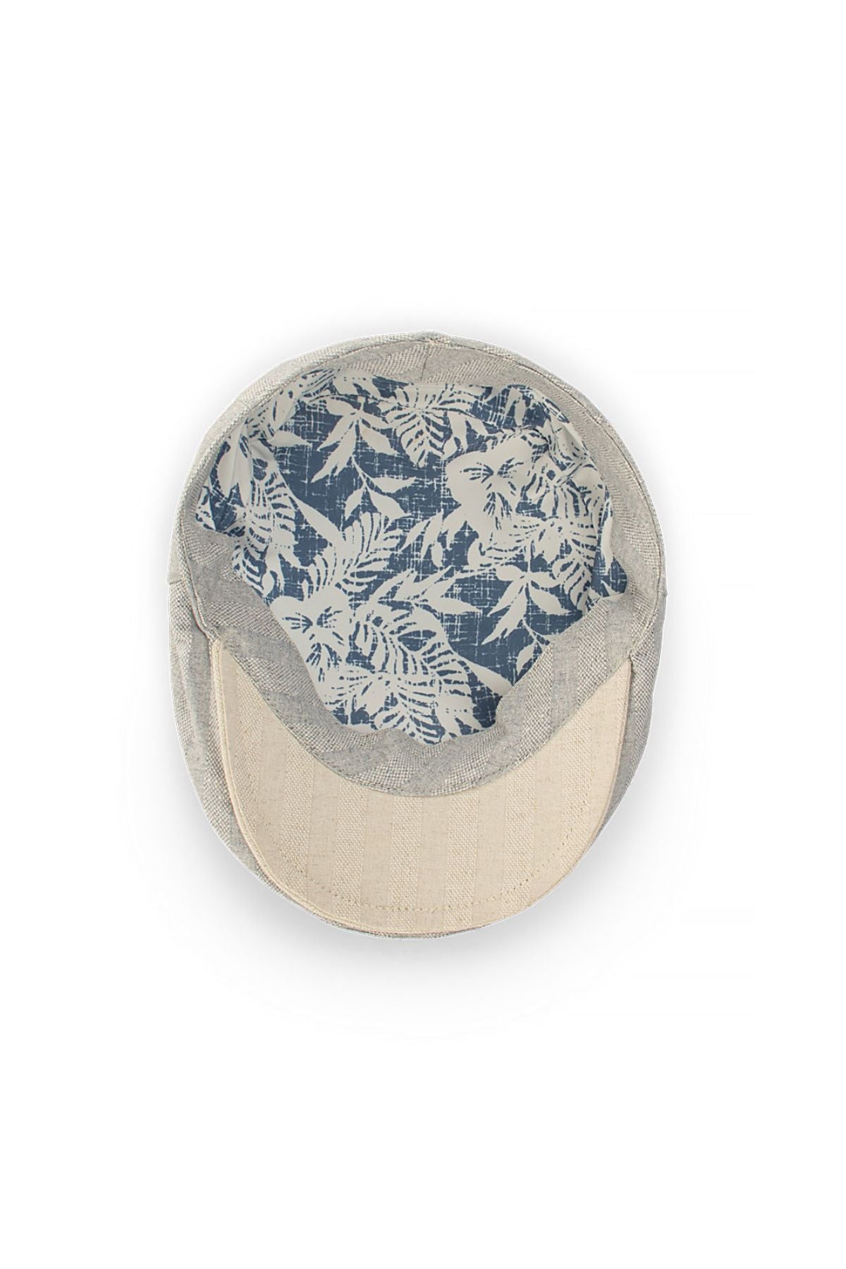 The Avenel Manhattan Linen Blend Textured Flat Cap features a light gray linen blend, a beige brim, and a blue and white floral-patterned inner lining, as seen from above.