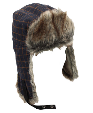 The Avenel Check Flying Cap is a plaid winter trapper hat with faux fur lining, ear flaps, and a blue and brown check pattern, inspired by the classic flying cap design. It features a black chin strap with metal snaps.
