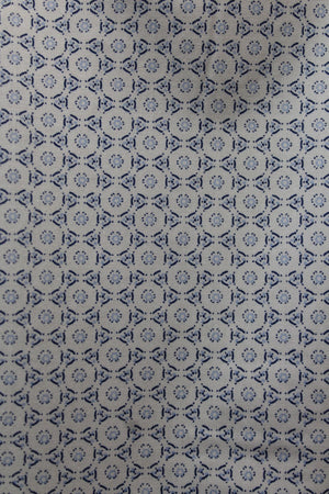 A close-up of the Back Bay Bamboo Soft Touch Print Short Sleeve Shirt, featuring a blue geometric pattern of circles and diamonds on light beige, made from a soft polyester cotton blend.