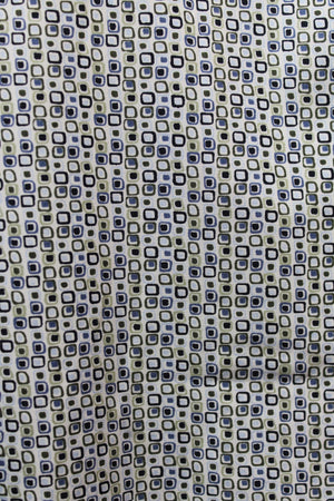 A close-up of fabric with small, overlapping black, blue, and beige square outlines on a light background. This geometric, retro-style print is perfect for the Back Bay Bamboo Soft Touch Print Short Sleeve Shirt.